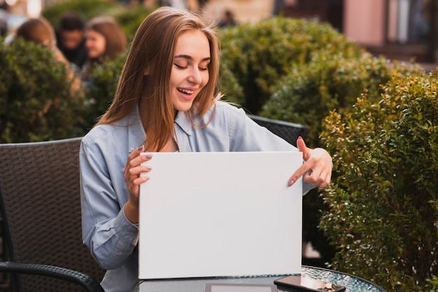 Beautiful female pointing at paper sheet