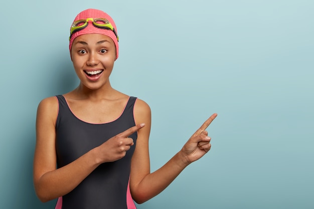 Beautiful female swimmer posing with goggles