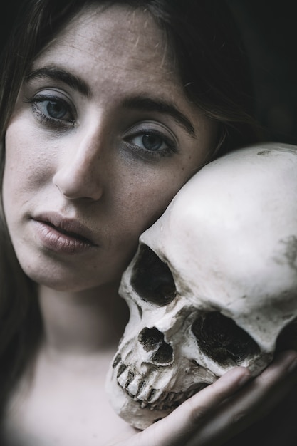 Beautiful female with human skull