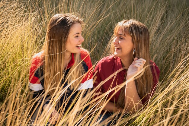 Beautiful females sitting on grass