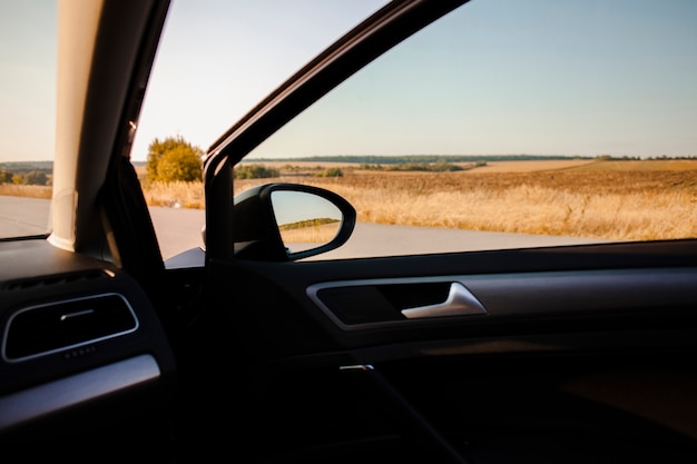 Beautiful field view from elegant car