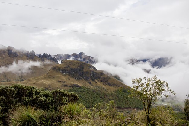 Beautiful field with amazing rocky mountains hills and amazing cloudy sky