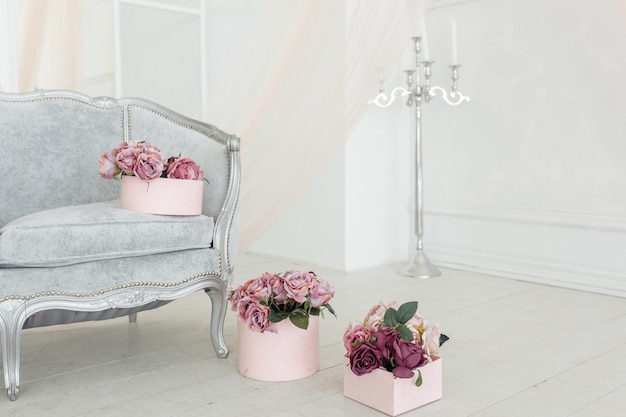 beautiful flower beige pink purple peony bouquet on floor in the pink box in light white room