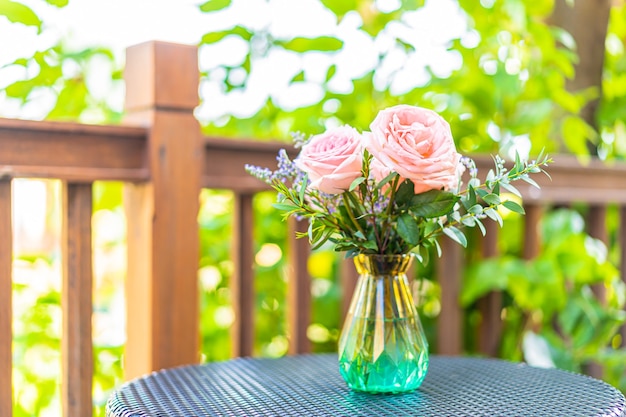 Beautiful flower in vase on table decoration with garden view