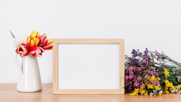 Free photo beautiful flowers and empty frame