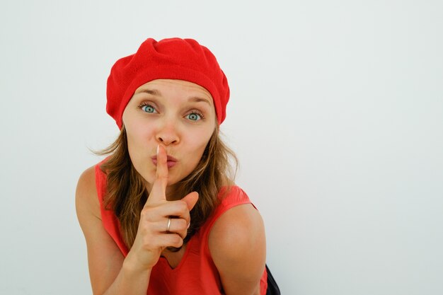 Beautiful French woman showing shh gesture