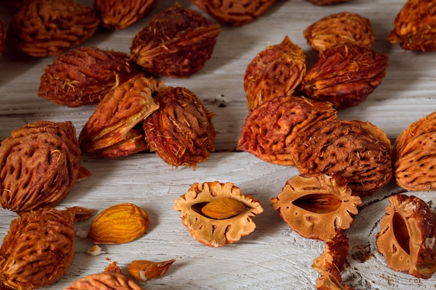 beautiful fruit peach and lots of peach pits from peaches on wooden background