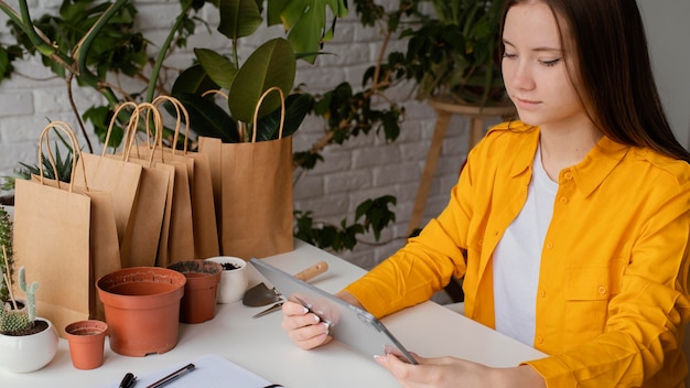 Free photo beautiful gardener checking her tablet