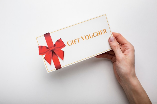 Free photo beautiful gift voucher with hand