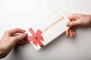 Free photo beautiful gift voucher with hand