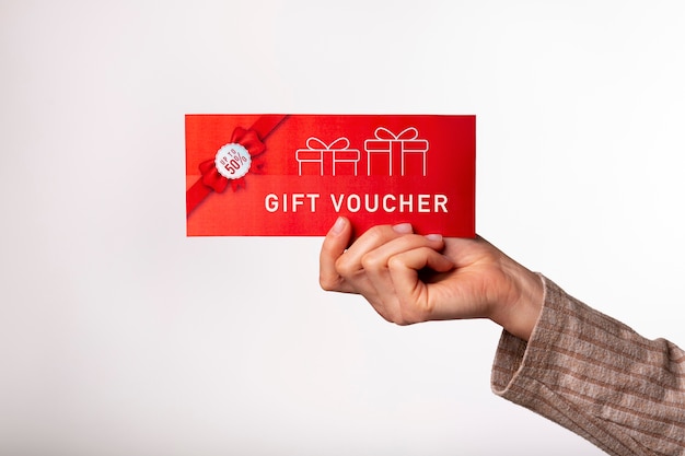 Free photo beautiful gift voucher with hand