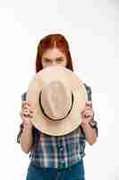 Free photo beautiful ginger girl with hat over white wall.