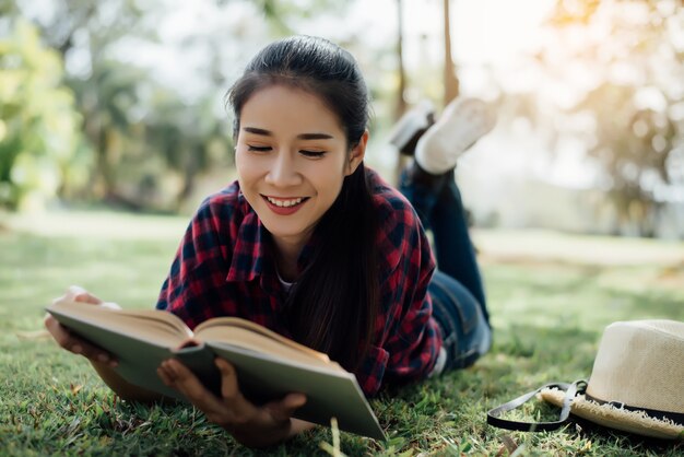 Beautiful girl in autumn forest reading a book