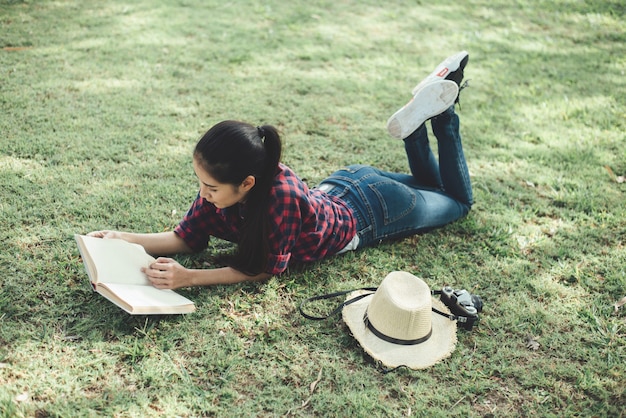 Beautiful girl in autumn forest reading a book