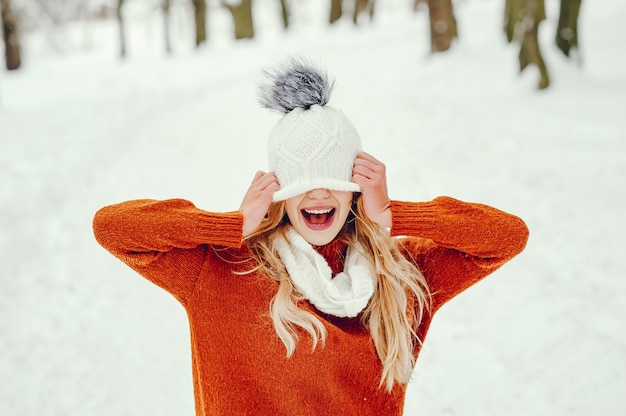 Beautiful girl in a cute orange sweater