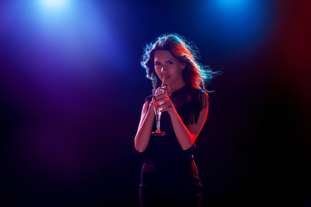 The beautiful girl dancing at the party drinking champagne