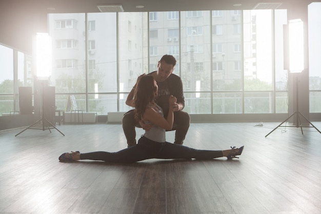 Beautiful girl doing slip while dancing kizomba with her partner. Skillful dancer. Passionate dancer.