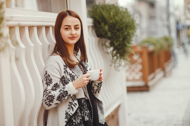 Beautiful girl drinks coffee