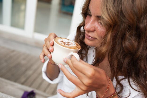 Beautiful girl drinks coffee.