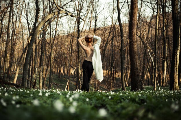 A beautiful girl enjoys the forest and nature