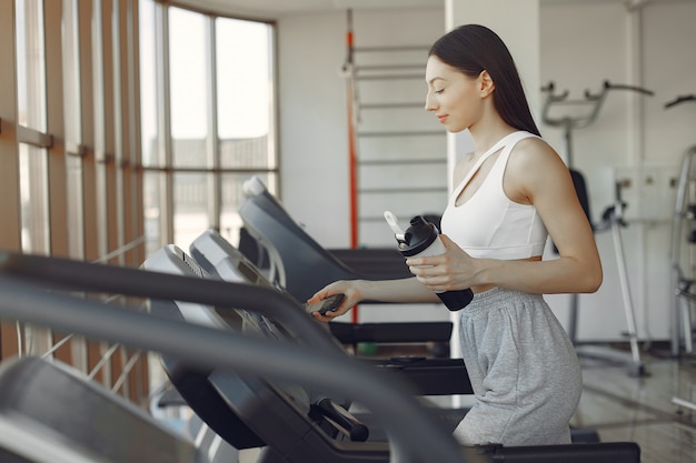 A beautiful girl in a gym on a racetrack