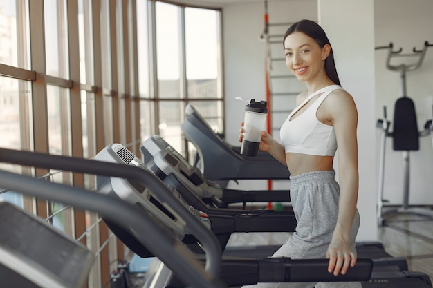 A beautiful girl in a gym on a racetrack