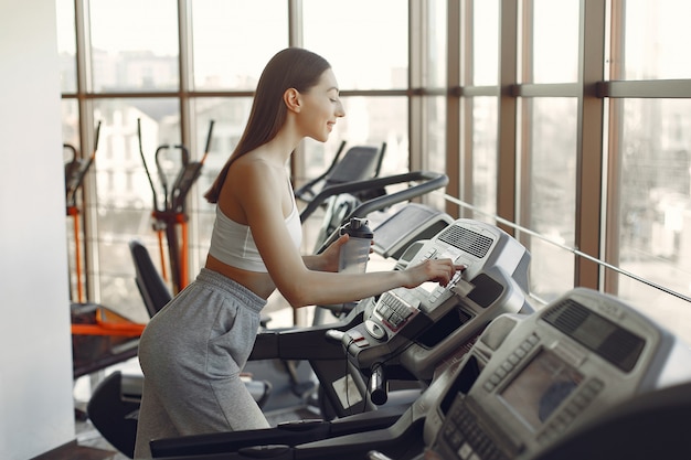 A beautiful girl in a gym on a racetrack