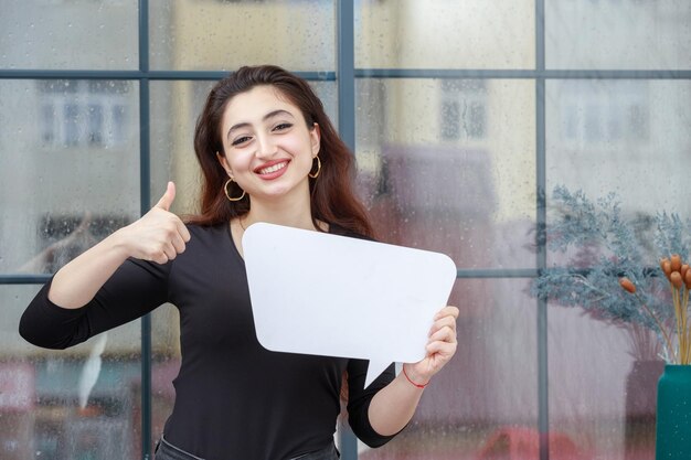 Beautiful girl holding ballon chat and gesture thumb up High quality photo