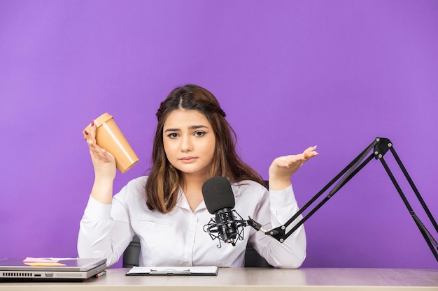 Beautiful girl holding her coffee cup and doesn39t know what to do High quality photo