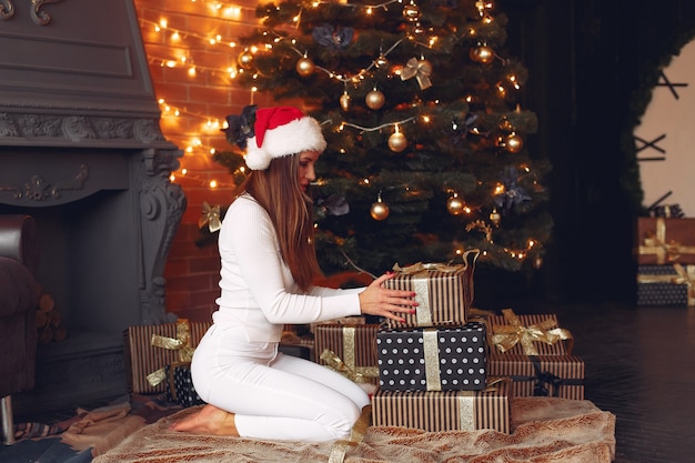 Beautiful girl at home near christmas tree