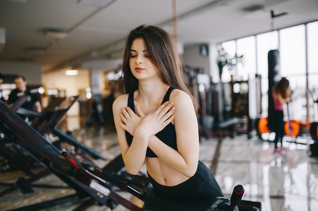 A beautiful girl is engaged in a gym