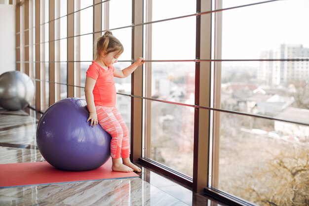 A beautiful girl is engaged in a gym