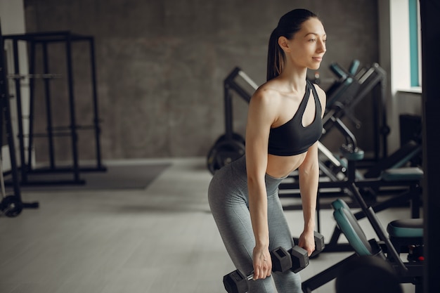 A beautiful girl is engaged in a gym