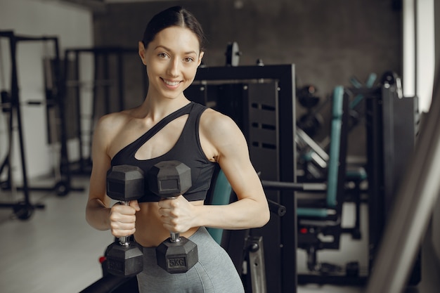 A beautiful girl is engaged in a gym