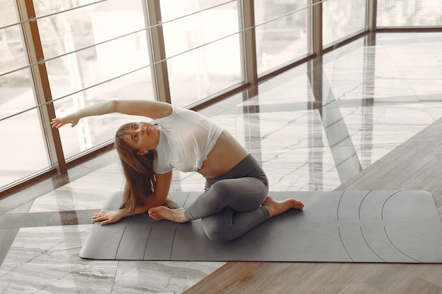 A beautiful girl is engaged in a gym