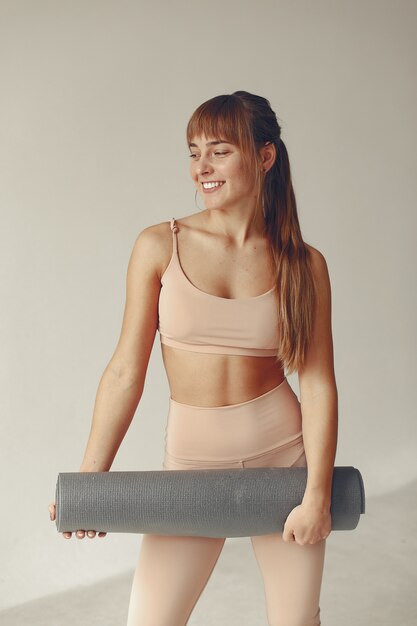 A beautiful girl is engaged in a yoga studio