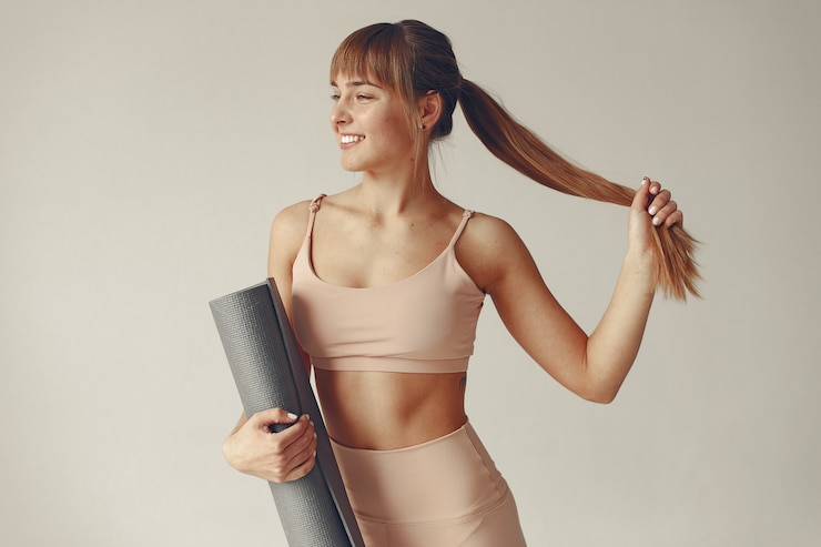 Free Photo a beautiful girl is engaged in a yoga studio