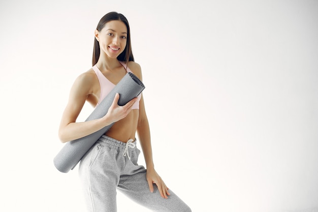 A beautiful girl is engaged in a yoga studio