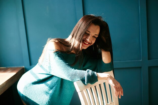 Beautiful girl laughs in the light of the sun