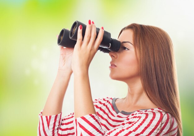 beautiful girl looking through binoculars