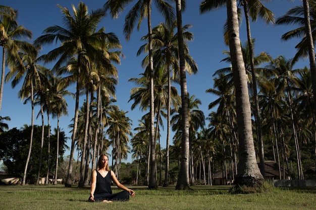 Beautiful girl meditates in nature. 