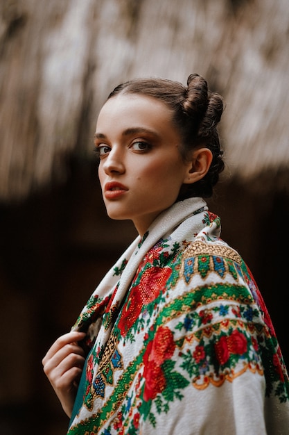 Beautiful girl posing in an embroidered dress