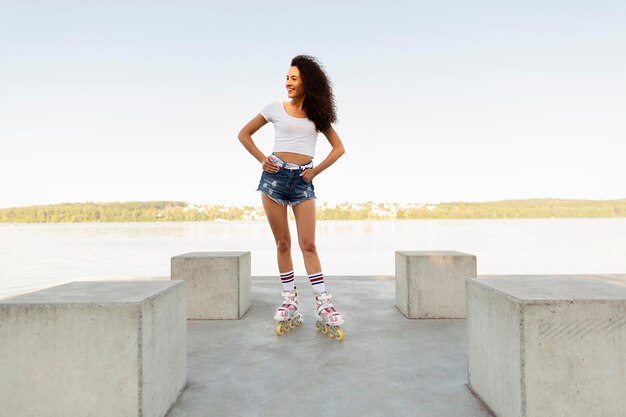 Beautiful girl posing in rollerblades outside