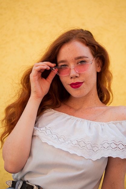 Foto gratuita bella ragazza in posa con gli occhiali da sole