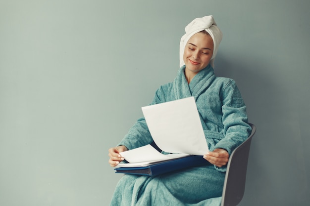 Free photo beautiful girl sitting  in a blue bathrobe