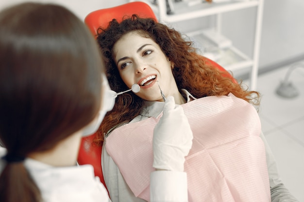 Bella ragazza che si siede nell'ufficio del dentista