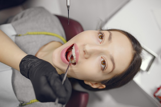 Beautiful girl sitting in the dentist's office