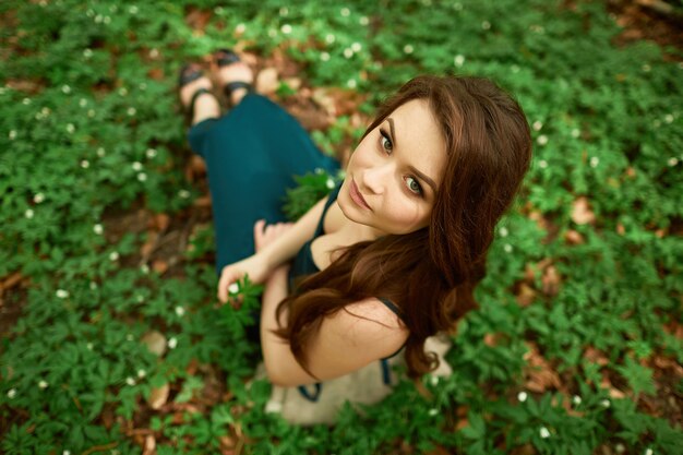 The beautiful girl sitting on the ground