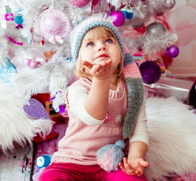 The beautiful girl  sitting near Christmas Tree