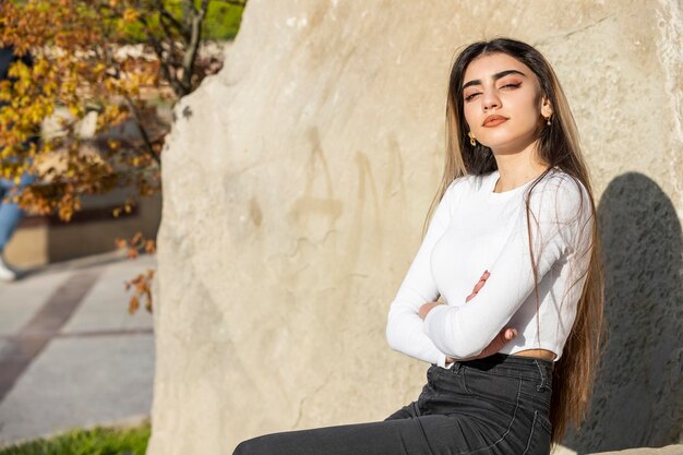 Beautiful girl sitting on the street on a sunny day